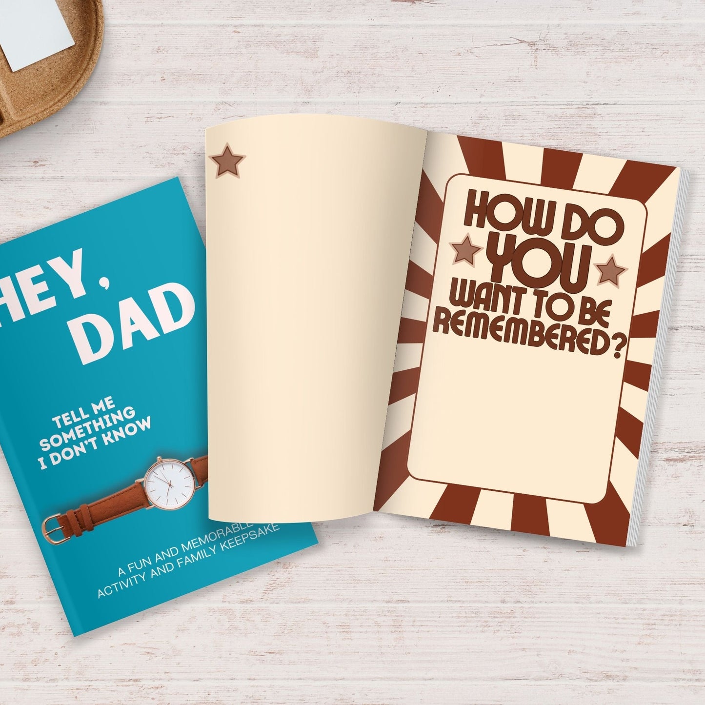 Hey, Dad! Tell Me Something I Don't Know journal with a blue cover and open pages featuring prompts for family memories.