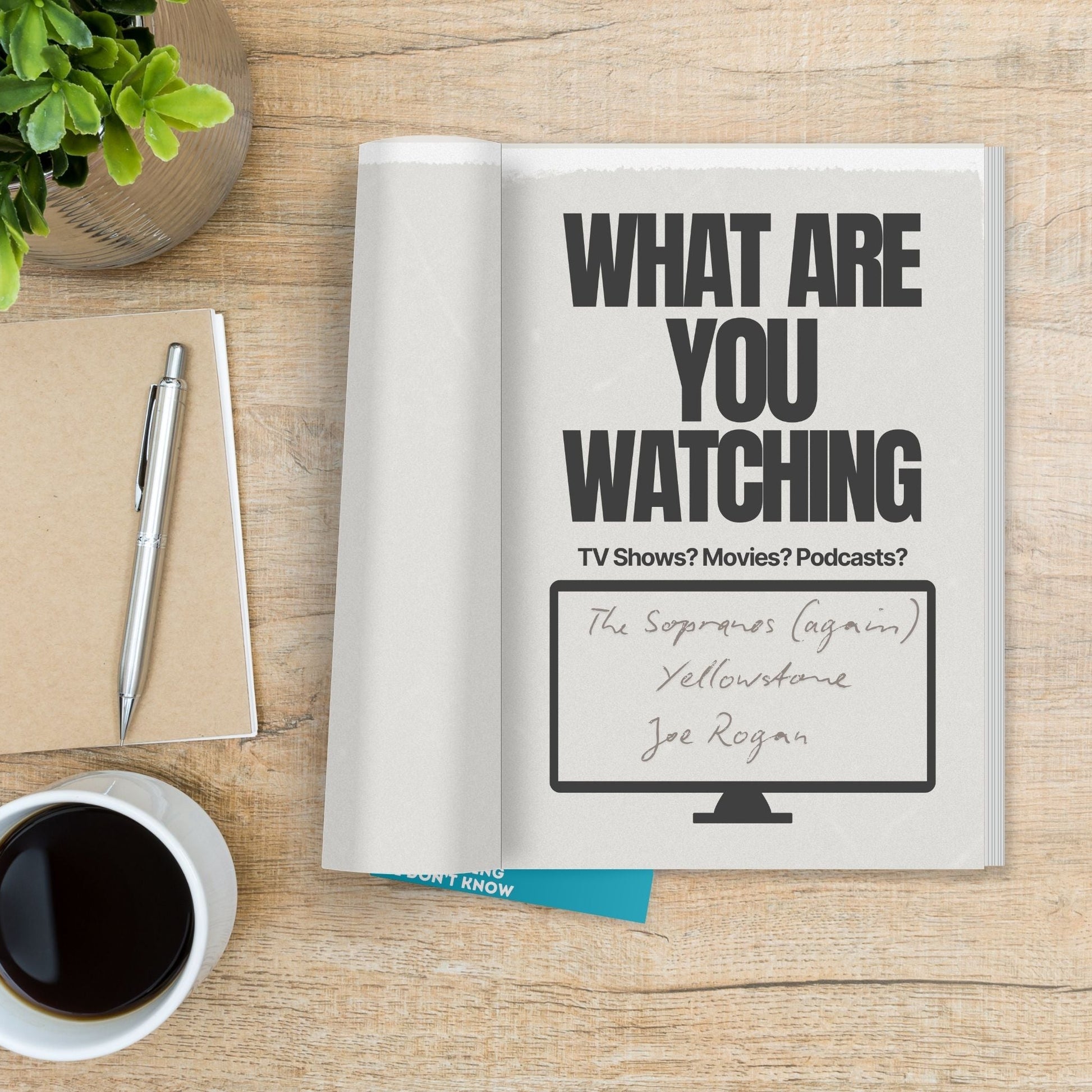 Hey, Dad! Tell Me Something I Don't Know journal with prompts about TV shows, movies, and podcasts on a wooden table.